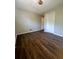 This bedroom features gorgeous wood flooring and a bright overhead light at 4701 Flat Shoals Rd, Union City, GA 30291