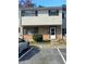 Two-story townhouse featuring brick and siding, complemented by black shutters and a paved parking area at 4701 Flat Shoals Rd, Union City, GA 30291
