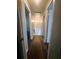 A long hallway with wood-look flooring leads to the bedrooms at 4701 Flat Shoals Rd, Union City, GA 30291