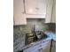 Close-up of a kitchen featuring a stainless steel sink and a neutral countertop at 4701 Flat Shoals Rd, Union City, GA 30291