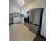 The kitchen has stainless steel appliances, white cabinetry and countertops, and neutral tiled flooring at 4701 Flat Shoals Rd, Union City, GA 30291