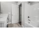 Clean bathroom with tub and shower and white door leading to the rest of the house at 6355 Akins Way, Cumming, GA 30041