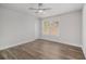 Minimalist bedroom with hardwood floors, a ceiling fan, and a window letting in natural light at 6355 Akins Way, Cumming, GA 30041