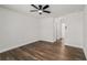 Spacious bedroom with hardwood floors, a ceiling fan, and an open layout with access to the bathroom at 6355 Akins Way, Cumming, GA 30041