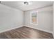 Bright bedroom featuring modern trim, fresh paint, and hardwood flooring at 6355 Akins Way, Cumming, GA 30041