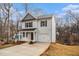 Charming two-story home featuring a welcoming front porch and attached garage at 6355 Akins Way, Cumming, GA 30041