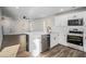 Modern kitchen featuring white cabinets, stainless steel appliances, and an island with a sink and dishwasher at 6355 Akins Way, Cumming, GA 30041