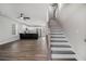 Open-concept living space featuring hardwood floors, a ceiling fan, and staircase leading to the second floor at 6355 Akins Way, Cumming, GA 30041
