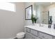Bathroom with gray cabinets, white countertop, silver faucet and leafy green plant at 1366 Creekside Nw Cir, Atlanta, GA 30318