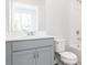 Well-lit bathroom featuring a gray vanity with chrome fixtures and a shower-tub combo at 1366 Creekside Nw Cir, Atlanta, GA 30318