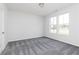 An empty bedroom with carpeted floors, neutral walls and natural light from two windows at 1366 Creekside Nw Cir, Atlanta, GA 30318