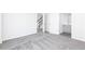 An open bedroom space featuring carpeted floors and access to a bathroom and stairway at 1366 Creekside Nw Cir, Atlanta, GA 30318