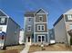 New construction two-story home featuring a yellow front door, brick foundation, and blue and gray siding at 1366 Creekside Nw Cir, Atlanta, GA 30318