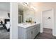 Bright main bathroom featuring double vanity, ample cabinet space, and a separate closet at 1366 Creekside Nw Cir, Atlanta, GA 30318