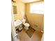 Cozy bathroom featuring a toilet, sink, window, and neutral colored walls at 3117 Janice Cir, Atlanta, GA 30341