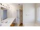 Bathroom features a double sink vanity, a large mirror with great lighting, and an open door to the toilet area at 3515 Devon Chase Rd, Atlanta, GA 30349