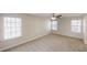 Large bedroom with multiple windows providing abundant natural light and ceiling fan at 3515 Devon Chase Rd, Atlanta, GA 30349