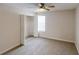 Bedroom features neutral carpet, a ceiling fan, window and closet, and an attached ensuite at 3515 Devon Chase Rd, Atlanta, GA 30349