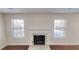 Classic fireplace with marble surround flanked by windows in a bright living space at 3515 Devon Chase Rd, Atlanta, GA 30349