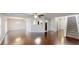 Open-concept living room with hardwood floors, stairs, and ample natural light at 3515 Devon Chase Rd, Atlanta, GA 30349