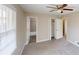 Bright bedroom with ceiling fan, neutral paint, and a large window with wood blinds at 3868 Prentiss Dr, Decatur, GA 30034