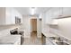 Kitchen featuring white cabinets, stainless steel appliances, and laminate floors at 3868 Prentiss Dr, Decatur, GA 30034