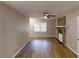 Open living room with hardwood floors, a ceiling fan, and a brick fireplace, providing a cozy atmosphere at 3868 Prentiss Dr, Decatur, GA 30034