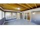 Bright sunroom featuring wood look flooring, exposed ceiling, and sliding glass doors to the exterior at 3868 Prentiss Dr, Decatur, GA 30034