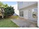 Backyard view with patio, grassy area, and exterior of the townhouse showcasing gray siding and windows at 4917 Walden Lake Sq, Decatur, GA 30035
