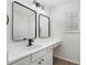 Bathroom featuring a vanity with double mirrors and a window providing natural light at 4917 Walden Lake Sq, Decatur, GA 30035