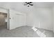 This bedroom features a ceiling fan, gray carpet, and a spacious closet for storage at 4917 Walden Lake Sq, Decatur, GA 30035