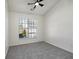 Bright bedroom featuring neutral carpet, ceiling fan, and a large window for ample natural light at 4917 Walden Lake Sq, Decatur, GA 30035