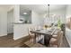 Contemporary dining room with modern lighting, stylish table setting, and access to the kitchen at 4917 Walden Lake Sq, Decatur, GA 30035