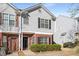Charming two-story townhouse with gray siding, brick accents, and lush landscaping at 4917 Walden Lake Sq, Decatur, GA 30035