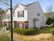 Two-story townhouse with gray siding, brick accents, and mature landscaping surrounding the property at 4917 Walden Lake Sq, Decatur, GA 30035