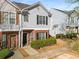 Two-story townhouse boasts brick accents, gray siding, and lush landscaping for curb appeal at 4917 Walden Lake Sq, Decatur, GA 30035