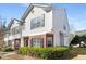 Two-story townhouse displays gray siding, brick accents, and a well-maintained landscape at 4917 Walden Lake Sq, Decatur, GA 30035