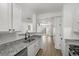 Open concept kitchen with granite countertops, modern faucet, and an open view into the living room at 4917 Walden Lake Sq, Decatur, GA 30035