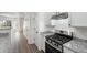 Bright kitchen area showing stainless steel oven and granite countertops and open view to living room at 4917 Walden Lake Sq, Decatur, GA 30035