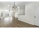 Bright living room with modern light fixture, fireplace, and open layout featuring beautiful flooring and ample natural light at 4917 Walden Lake Sq, Decatur, GA 30035