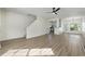 Spacious living area with hardwood floors, modern ceiling fan, and open layout to the kitchen at 4917 Walden Lake Sq, Decatur, GA 30035