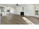 Bright living room with wood floors, fireplace, neutral paint, and modern ceiling fan at 4917 Walden Lake Sq, Decatur, GA 30035