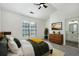 Cozy main bedroom with a large window, tray ceilings, wood dresser, and ensuite bathroom at 4917 Walden Lake Sq, Decatur, GA 30035