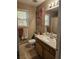 Bathroom with a single sink vanity, neutral tile, and a framed mirror at 68 Georgias Ln, Dallas, GA 30157