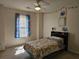 Bright bedroom with a patterned comforter, ceiling fan, and a large window at 68 Georgias Ln, Dallas, GA 30157