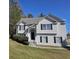 Charming two-story home with black shutters, arched entry and well-maintained lawn on a sunny day at 68 Georgias Ln, Dallas, GA 30157