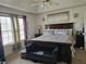 Main bedroom featuring a tray ceiling, plush bedding, and natural light at 68 Georgias Ln, Dallas, GA 30157