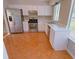 Bright kitchen featuring stainless steel appliances, white cabinets, and tile flooring at 566 Aberdeen Dr, Stone Mountain, GA 30083