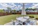 Backyard featuring a manicured lawn, patio furniture, and privacy fence perfect for entertaining at 1788 Hanover West Ct, Lawrenceville, GA 30043