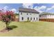 Expansive backyard with green lawn, patio set, wood fence, and appealing landscaping at 1788 Hanover West Ct, Lawrenceville, GA 30043